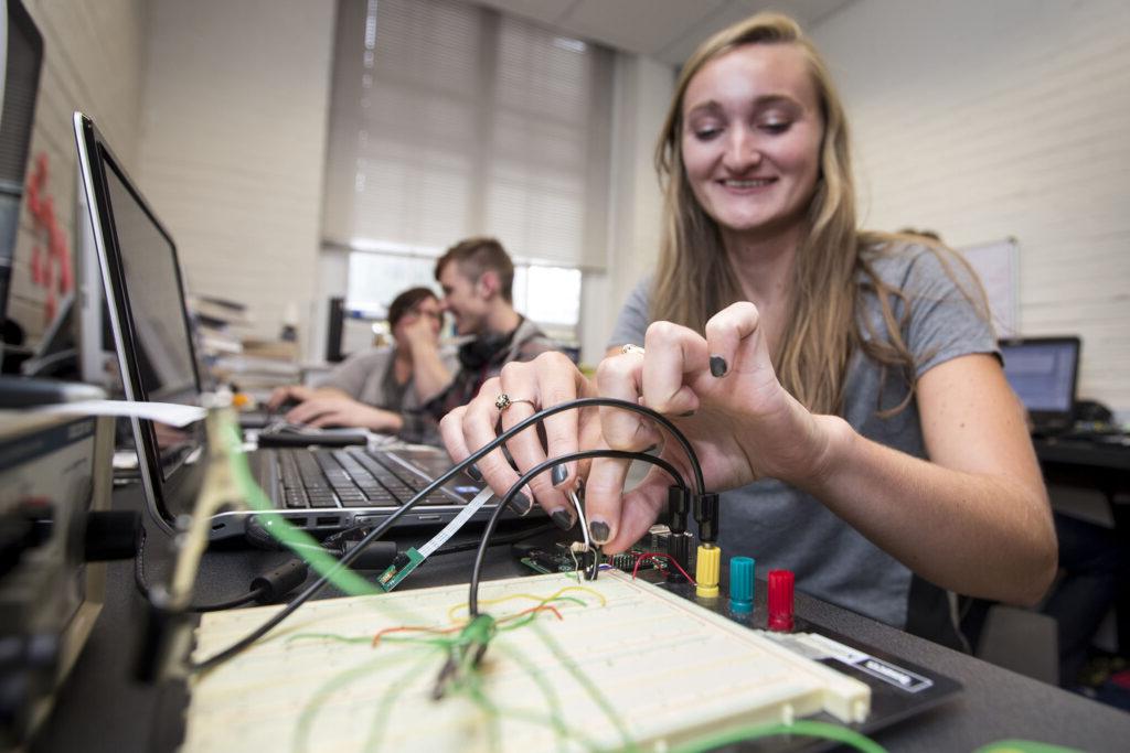 Student wires sensor configurations on her summer research project.