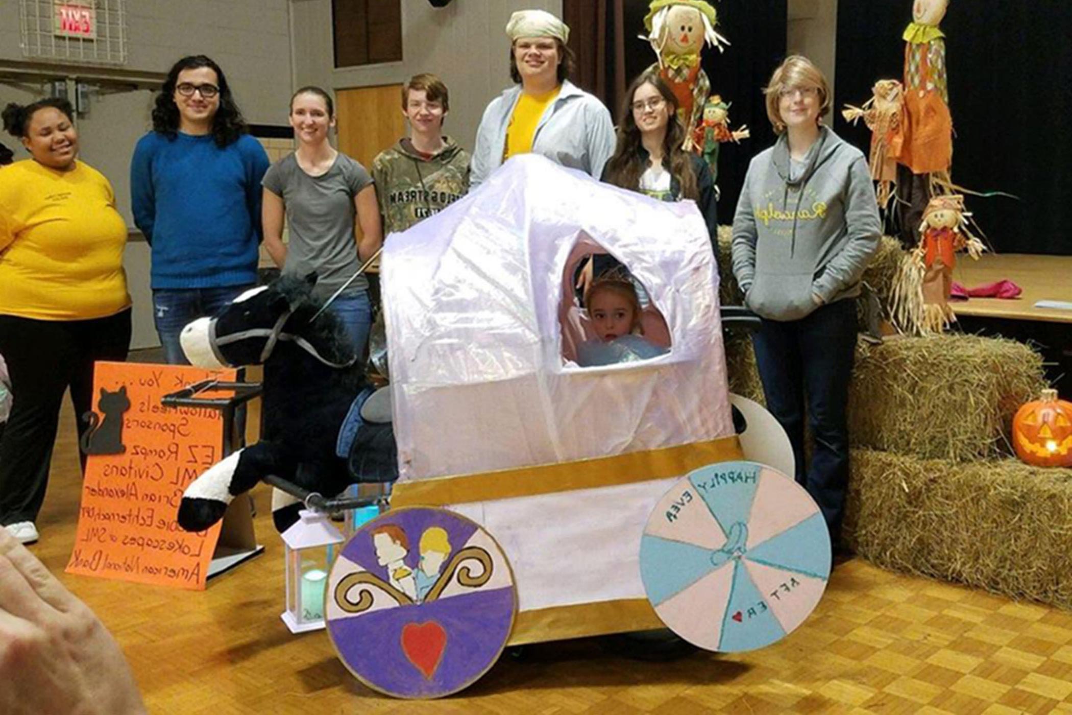 Randolpk College students create a Cinderella themed wheelchair halloween costume for a local girl.